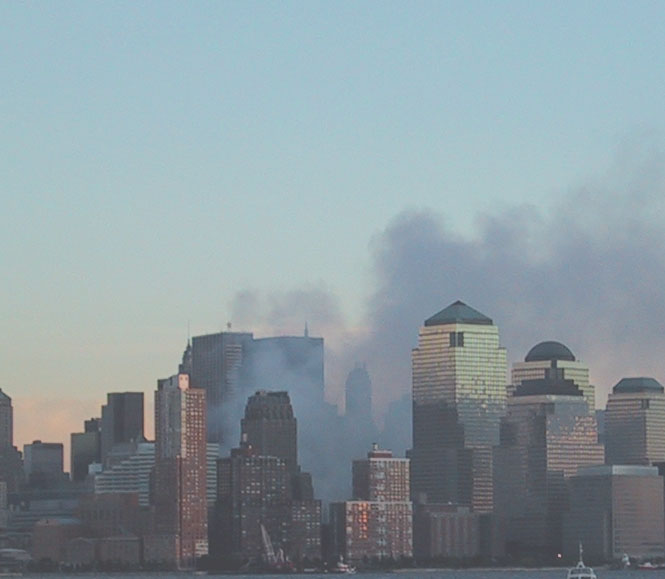 Former site of the World Trade Center on 9/14/01, with smoke still rising