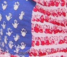 Close-up of children's handprints forming the stars and stripes
